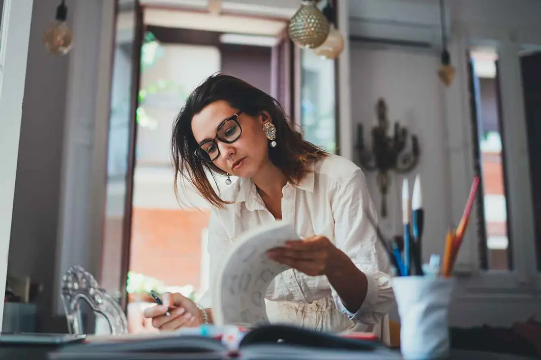 An owner reading through papers at her desk.